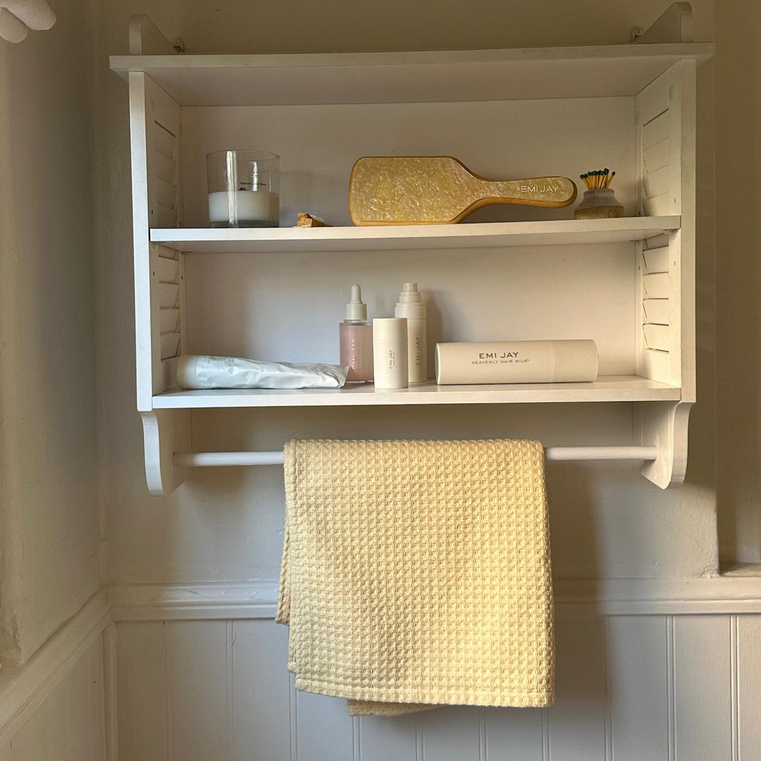 Heavenly Hair Towel in Buttercup on towel rack below emi jay hair care and accessories on shelves