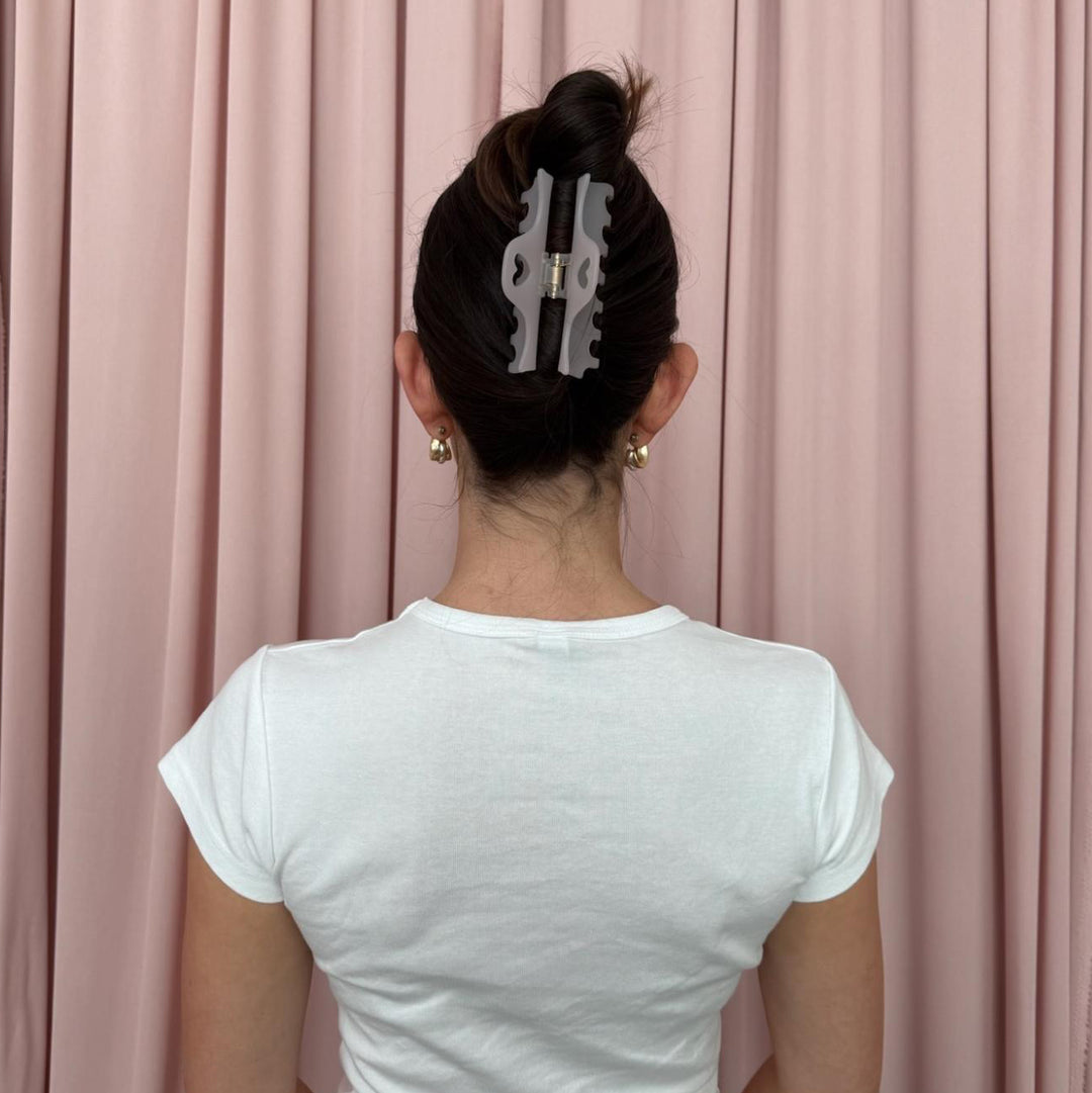model standing in front of pink curtain with Heartbreaker Clip in Lilac Smoke in hair