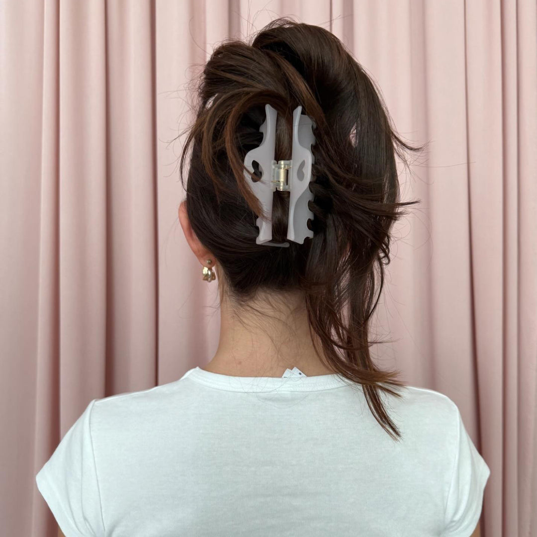 model standing in front of pink curtain wearing Heartbreaker Clip in Pink Smoke in hair 