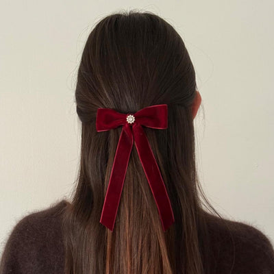 model wearing Iconic Velvet Bow Barrette in Cabernet in hair