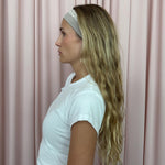 model standing in front of pink curtain wearing Infinity Headband in Grey Smoke in hair