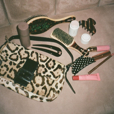 assorted emi jay hair care and accessories on couch