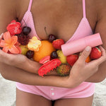 model holding aura hair + body mist in lychee baby, assorted fruit, and emi jay hair clips