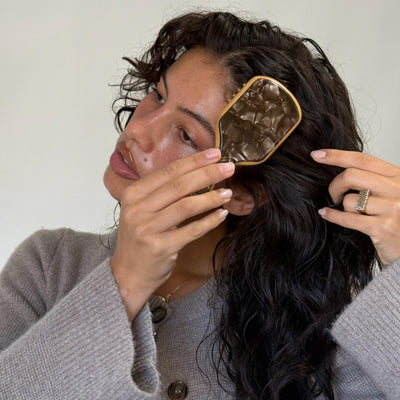 model brushing hair with Mini Bamboo Paddle Brush in Toasted Sugar