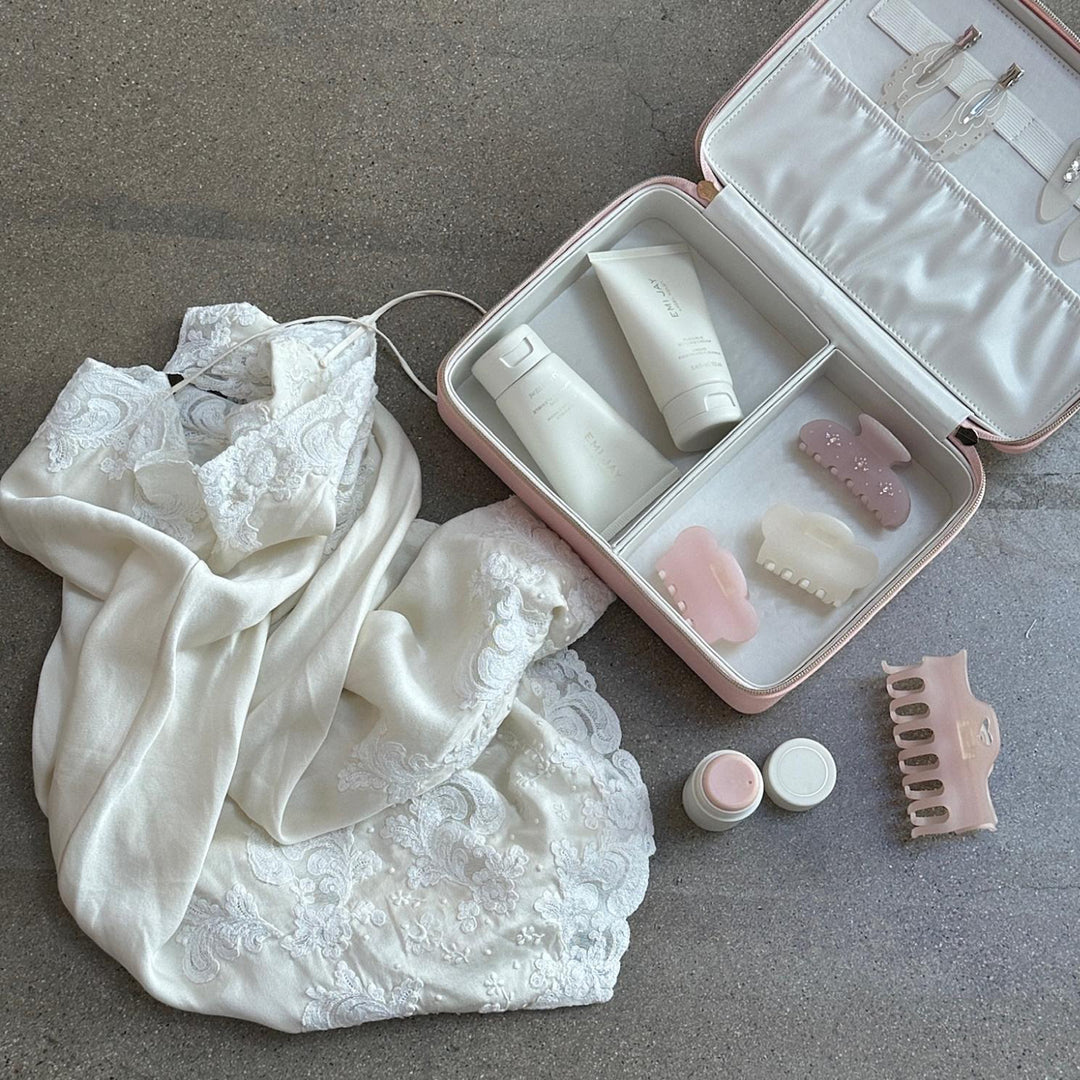 assorted emi jay hair care and accessories in vanity case neck to white dress
