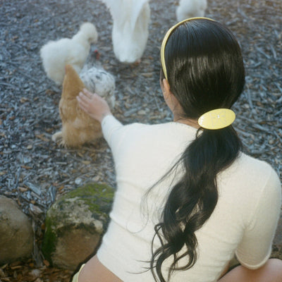 model wearing Ponytail Barrette in Lemon Drop in hair