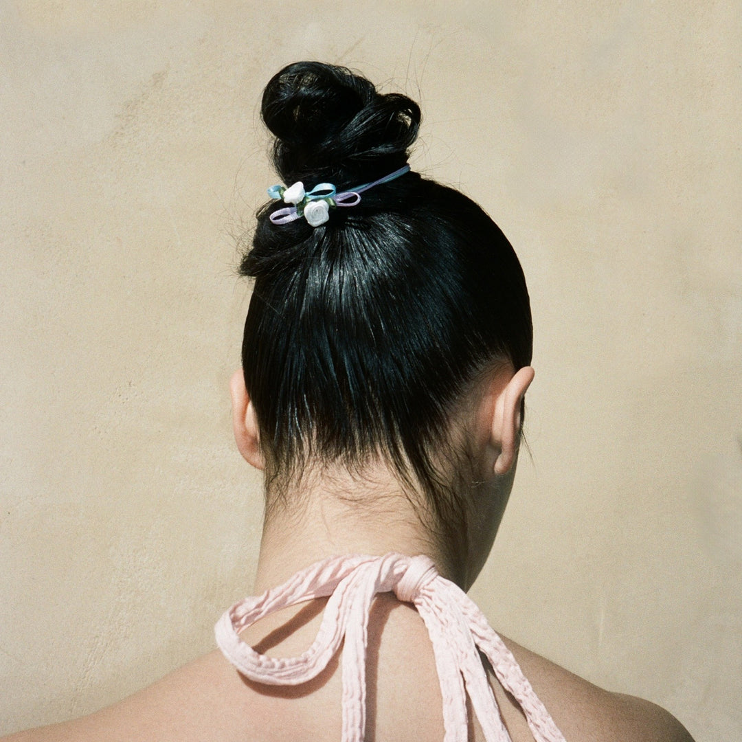 model wearing Ponytail Holder Set of 4 in Baby Rosette in hair
