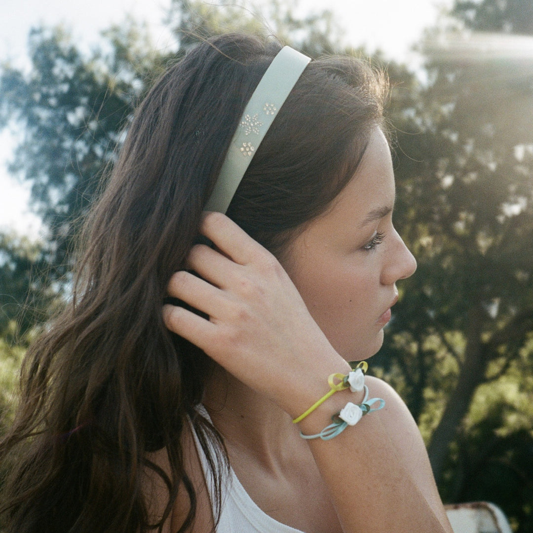 model wearing Ponytail Holder Set of 4 in Baby Rosette on wrist