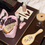 assorted emi jay hair care and accessories on hotel table