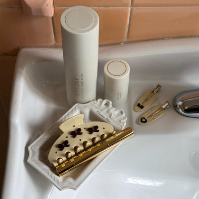 Heavenly Hair Milk and Angelstick sinkside with assorted Emi Jay hair accessories.