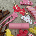 aura hair + body mist in lychee baby on sand with assorted emi jay hair accessories