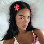 model laying in bed wearing Popstar Clips in Hibiscus Beach in hair
