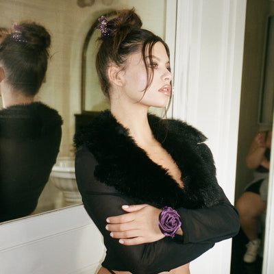 model wearing Rosette Scrunchie in Violet on wrist