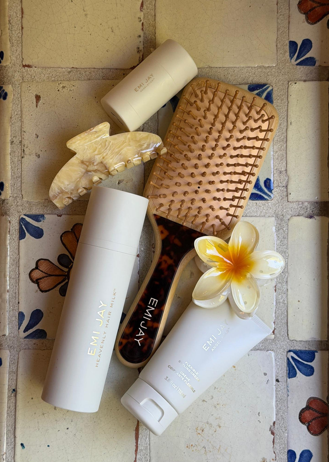 emi jay hair care and accessories on tile backdrop
