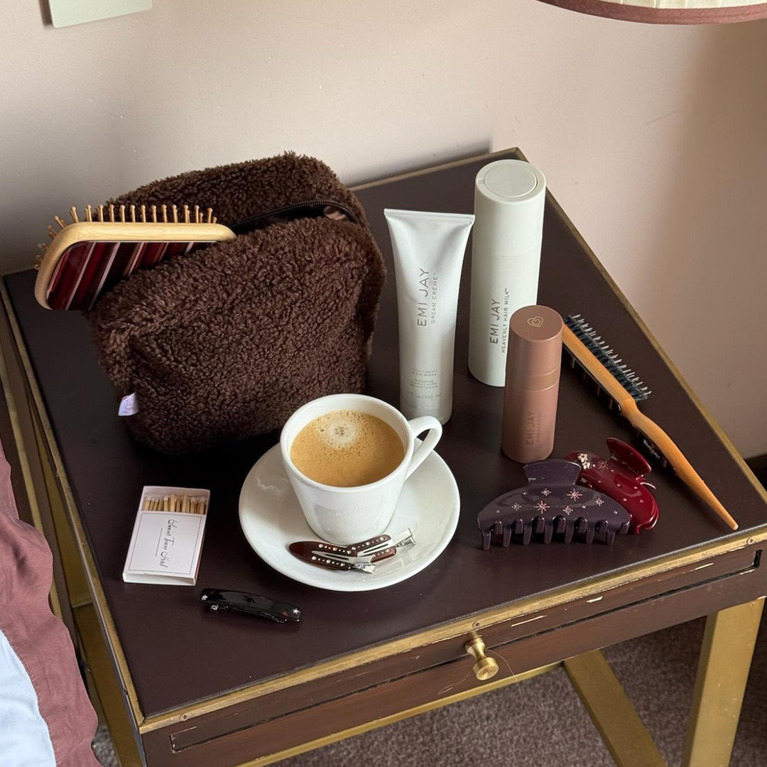 assorted emi jay hair care and accessories on table with coffee and matches