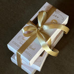 Multiple Sweet and Sleek styling sets with gold ribbon and bow.