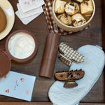 assorted emi jay hair care and accessories next to hot cocoa with emi jay marshmallows