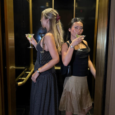 models wearing emi jay hair accessories in elevator with martinis