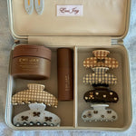 assorted emi jay hair care and accessories in vanity case