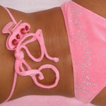 model wearing Sweetheart Clip in Palm Blossom clipped to the strap of Lychee Baby bikini top