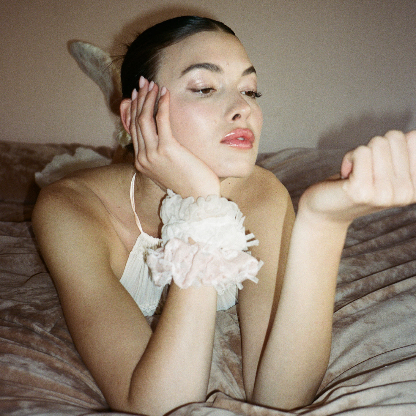 closeup of model wearing Tutu Scrunchies in Ballet and Whipped Creamon wrist
