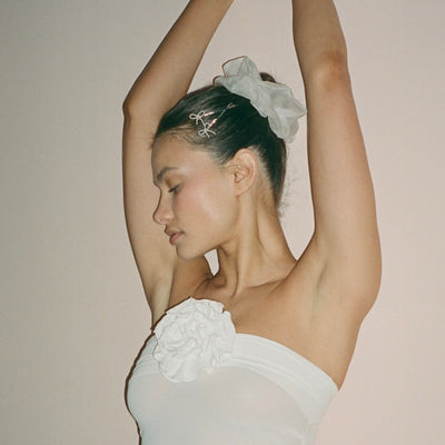 model with arms raised wearing Cloud Scrunchie in Storm Silk Organza + Barrette Set in Take a Bow