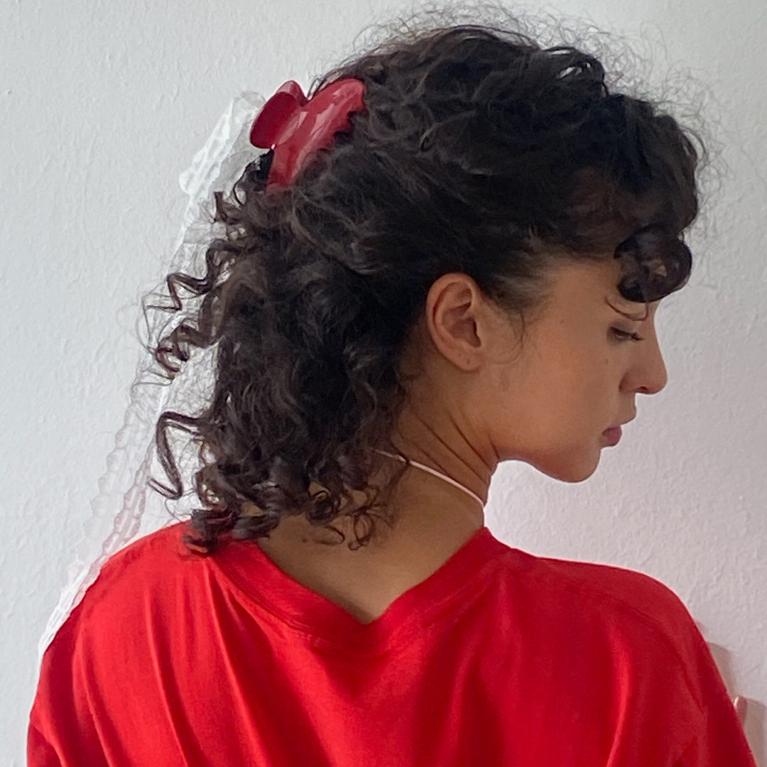 model showing how to wear Big Effing Clip in Cherry Kiss in curly hair