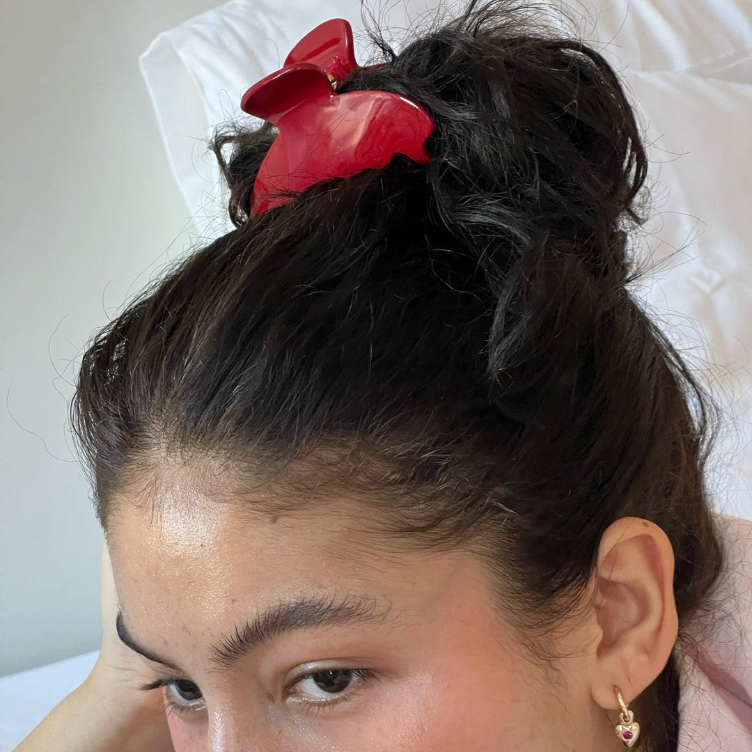 closeup of model showing how to wear Big Effing Clip in Cherry Kiss in hair