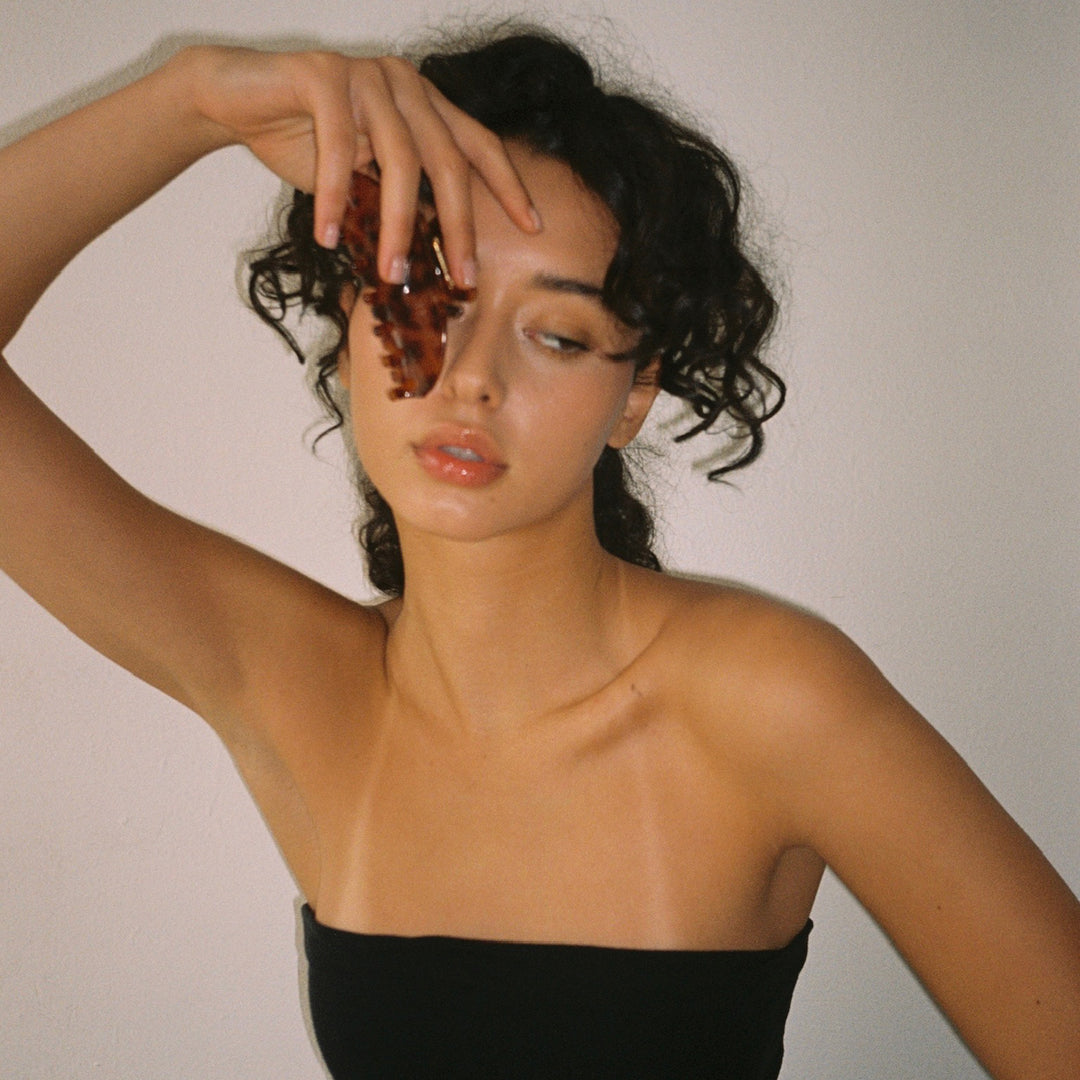 model holding Big Effing Clip in Tortoise