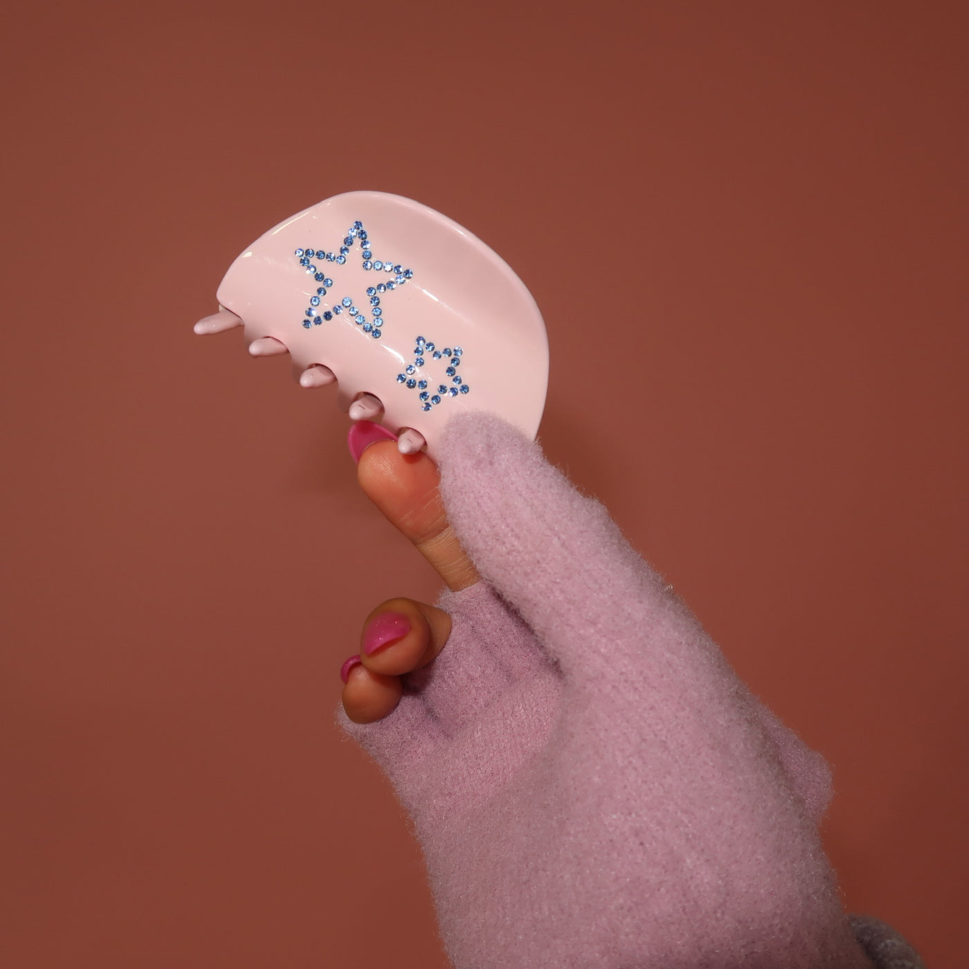 holding a Luna Clip in Pink Flurry