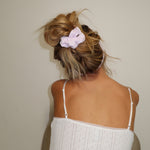 model wearing pointelle scrunchie in frosted lilac in hair