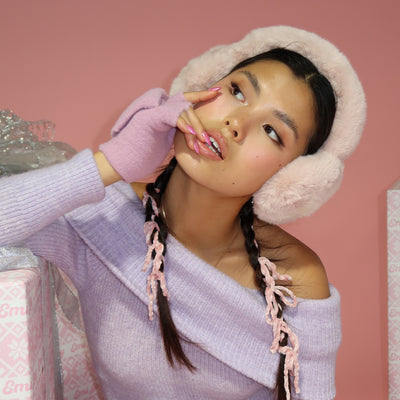 model looking away while wearing Sugar Muffs in Frosted Pink