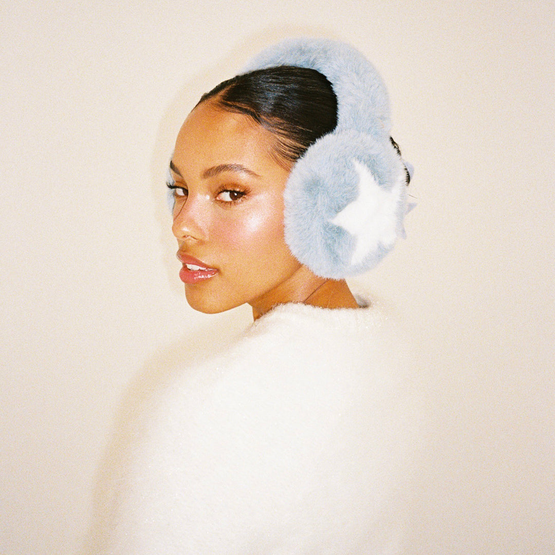 model turning head while wearing Sugar Muffs in Winter Dream