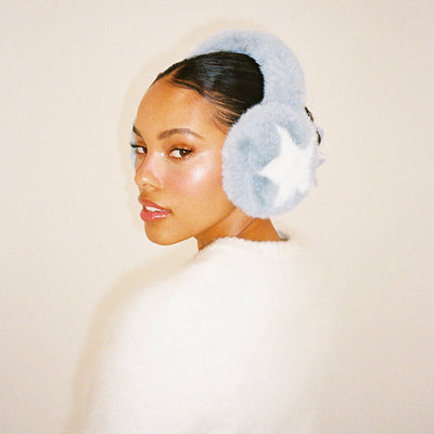 model turning head while wearing Sugar Muffs in Winter Dream