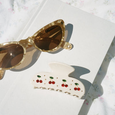 Sweetheart Clip in Cherry Pie on book with sunglasses